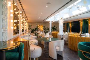 a restaurant with tables and chairs and a bar at The Delborough Lagos in Lagos