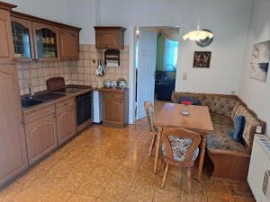 a kitchen and living room with a table and a couch at Hof Schumacher in Gumtow