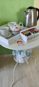 a white shelf with bowls and dishes on it at Le tre cime in Baranello