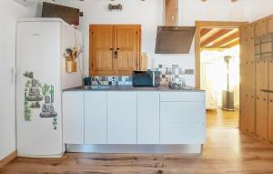 a kitchen with white cabinets and a white refrigerator at Beautiful stacaravan In Xtiva With Kitchenette in Xàtiva