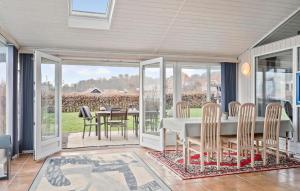 a dining room with a table and chairs at Cozy Home In Sjølund With Sauna in Sjølund
