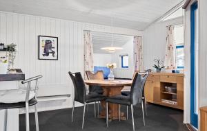 a dining room with a table and chairs at Cozy Home In Sjølund With Sauna in Sjølund