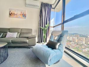 a living room with a couch and a chair at Urban Suites #High floor view #Infinity Pool #Georgetown #4pax #2BR 2bath #2 Queen #Quality well maintained #Private host in Jelutong