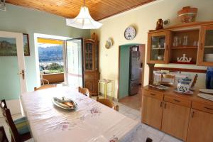 a kitchen with a table and a dining room at DINO apartma studio in soba - DINO Apartment Studio and Room in Portorož +45 photos