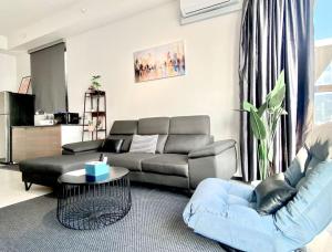 a living room with a couch and a table at Urban Suites #High floor view #Infinity Pool #Georgetown #4pax #2BR 2bath #2 Queen #Quality well maintained #Private host in Jelutong