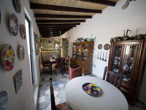 a dining room with a white table and chairs and a room with a dining table at Guest House Bellaguarda in Altea