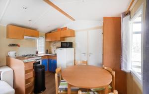 a small kitchen with a wooden table and a small dining room at 3 Bedroom Amazing Home In Barjac in Barjac