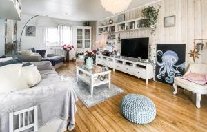a living room with a couch and a tv at Amazing Home In Les Sables-D'olonne in Les Sables-dʼOlonne