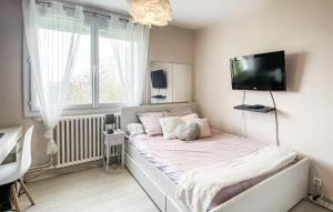a bedroom with a bed with a flat screen tv on the wall at Amazing Home In Les Sables-D'olonne in Les Sables-dʼOlonne +3 photos