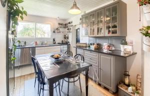 a kitchen with a table and chairs in it at Amazing Home In Les Sables-D'olonne in Les Sables-dʼOlonne