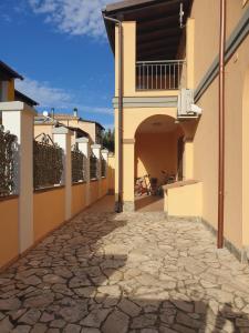 an alley with a building with a balcony at Lito’s house in Villasimius in Villasimius