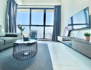 a living room with a couch and a table at Urban Suites #High floor view #Infinity Pool #Georgetown #4pax #2BR 2bath #2 Queen #Quality well maintained #Private host in Jelutong