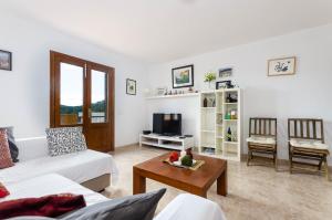 a living room with a couch and a table at YourHouse Sol i Mar 2 beach apartment in Cala Mesquida