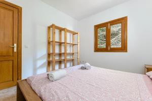 a bedroom with a bed with two towels on it at YourHouse Sol i Mar 2 beach apartment in Cala Mesquida +34 photos