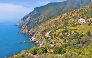 a house on a hill next to the ocean at Cozy Apartment In Chiavari With Wifi in Chiavari