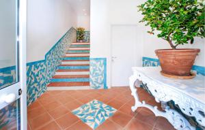 a blue and white staircase with a potted plant at Gorgeous Apartment In Deiva Marina in Deiva Marina