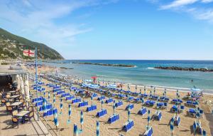a beach with chairs and umbrellas and the ocean at Gorgeous Apartment In Deiva Marina in Deiva Marina