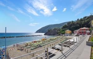 a beach with people on the sand and the water at Amazing Apartment In Deiva Marina With Wifi in Deiva Marina