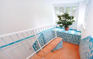 a staircase with blue and white tiles and a potted plant at Gorgeous Apartment In Deiva Marina in Deiva Marina +15 photos