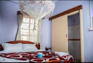 a bedroom with a large bed and a window at ARRAHMAN HOTEL AND RESTAURANT in Nairobi