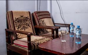 a table with two chairs and two bottles of water at ARRAHMAN HOTEL AND RESTAURANT in Nairobi