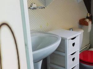a bathroom with a white sink and a mirror at Appart Duplex 8 pers avec Terrasse à Pra-Loup - FR-1-165A-170 in Uvernet-Fours +8 photos