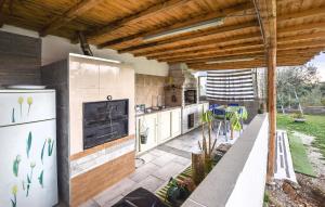 a kitchen with a stove and a refrigerator at Awesome Apartment In Comiso With Kitchen in Comiso