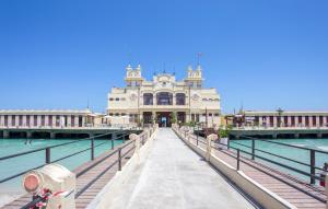 a building on a pier next to the water at Cozy Apartment In Mondello With Wifi in Mondello