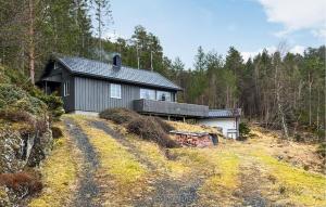 a house on a hill in the woods at Gorgeous Home In Sekken With House Sea View in Molde