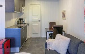 a living room with a couch and a kitchen at Nice Apartment In Bjorli With Wifi in Bjorli