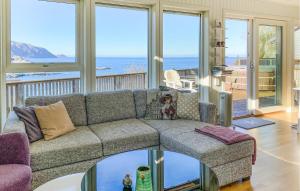 a living room with a couch and a view of the ocean at 2 Bedroom Lovely Home In Raudeberg in Raudeberg