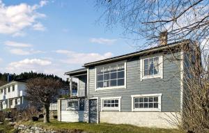 a gray house with white windows and a tree at 2 Bedroom Cozy Home In Skodje in Skodje +13 photos