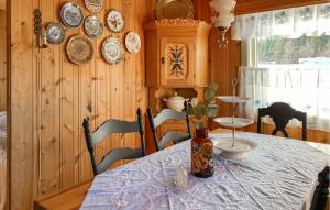 a dining room with a table and plates on the wall at 2 Bedroom Cozy Home In Skodje in Skodje