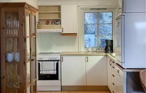 a kitchen with a white stove and a refrigerator at Lovely Home In Spangereid With Kitchen in Spangereid