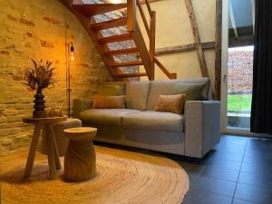 a living room with a couch and a table at Hotel De Hoogmolen in Oudsbergen 