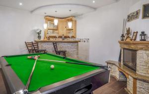 a room with a pool table and a fireplace at Gorgeous Home In Poronin With Wi-fi in Poronin