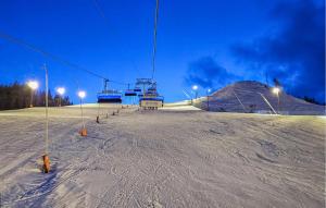 a ski lift sitting on top of a snow covered slope at Nice Home In Kongsberg With Kitchen in Kongsberg