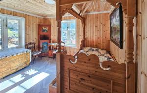 a log cabin bedroom with a large bed and windows at Lovely Home In Stathelle With Wifi in Stathelle