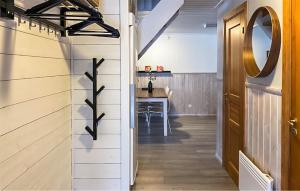 a hallway with a table and a mirror on the wall at Gorgeous Apartment In Sysslebäck in Sysslebäck