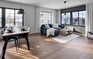 a living room with a blue couch and a table at Stunning Apartment In Idre With Sauna in Idre