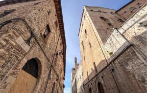 two towers of a building with a blue sky in the background at Gorgeous Apartment In Gubbio With Wifi in Gubbio +18 photos
