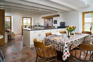 a kitchen with a table with a polka dot table cloth at Bryn Isaf Swyddffynnon in Ystrad-Meurig