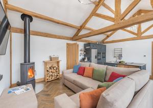 a living room with a couch and a wood stove at River View Lodge in Allendale Town