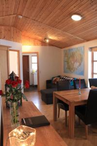 a living room with a table and a couch at Arabær Holiday Home in Arabaer