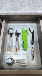 a plastic tray with utensils in a drawer at Mountain View One in Tashkent
