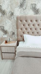 a bedroom with a bed and a wall with flowers at Mountain View One in Tashkent +25 photos