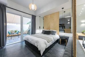 a bedroom with a large bed and a balcony at Small minimal paradise in the center of the city in Athens