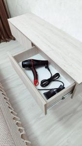 a black object is sitting in a wooden drawer at Mountain View One in Tashkent