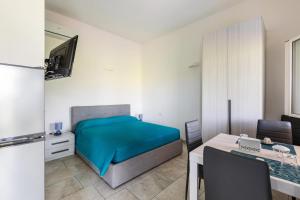 萊韋拉諾的住宿－Villino Cento passi by BarbarHouse，一间卧室配有一张床、一张桌子和一张书桌