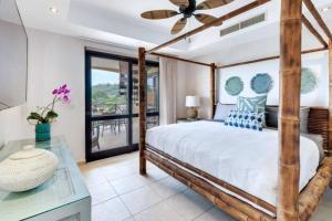 a bedroom with a large bed with a ceiling fan at Rooftop balcony oceanfront PH condo with King beds in Jacó +37 photos